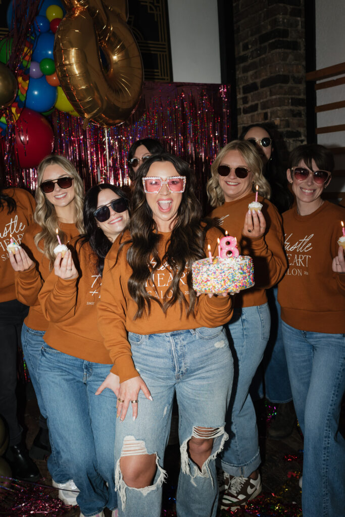 Team picture of the hair stylists at Hustle + Heart Salon celebrating H+H's 8th birthday!